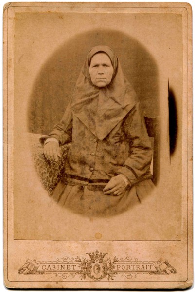 An elderly woman in a headscarf.