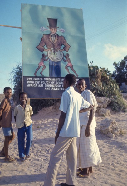 African people near anti world imperialists billboard, 70's