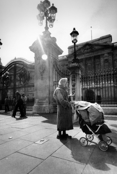 Homeless woman in front of the royal palace of london, uk, 70's