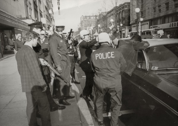 Suspect two black people looters are serched by police in downton washington, 1968