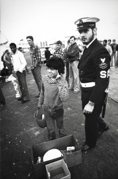 Little boy street vendor near an american soldier of saratoga aircraft carrier, 80's