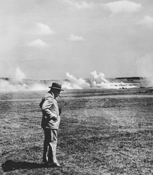 Mr Churchill, cigar in mouth watching realistic mock battle in the Southern Command using live ammunition.