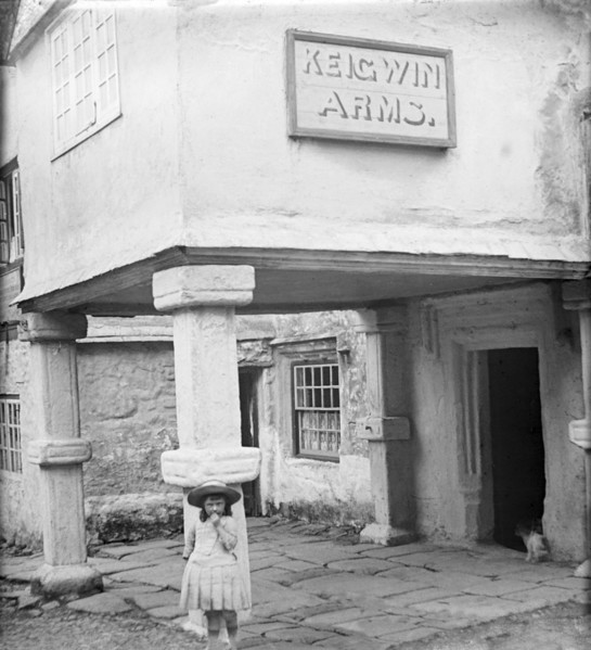 A young girl standing in front of Keigwin Arms Hotel.