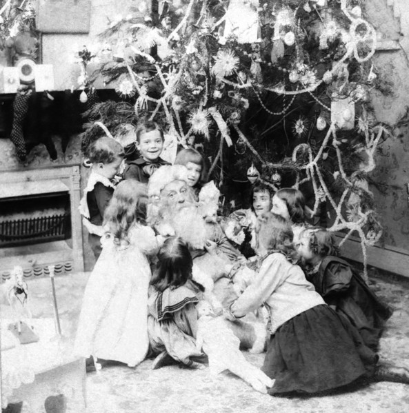 Santa Claus with lots of children and a Christmas tree.