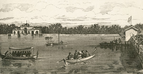 People boating on the lake in the Retiro Park.
