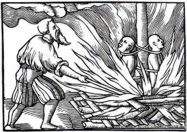 Burning of witches in the 18th century, shaven witches tied to the stake, the torturer setting
