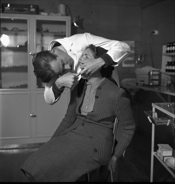 Dentist with patient, in the 40s