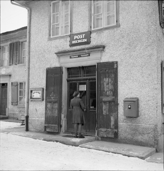 Woman in front of the post office in Rekingen AG 1950.
