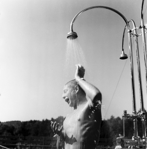 Young man taking a shower in the outdoor-swimmingpool Dolder in circa 1950