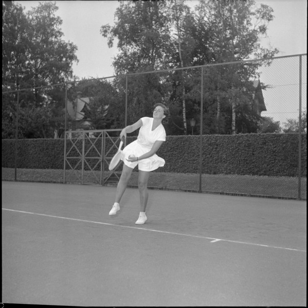 Jeannette Altwegg playing tennis, ca. 1955