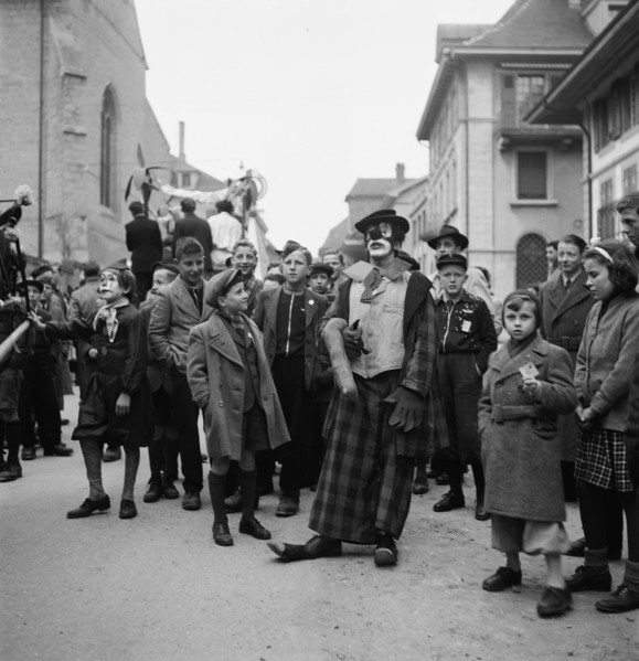 Clown and children at carnival parade in Payerne, 1946.