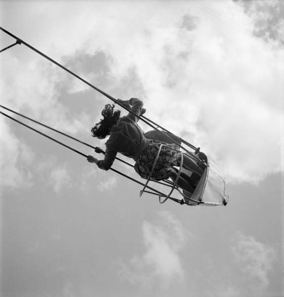 Primary school party in the woods; girl on swing boat 1945.
