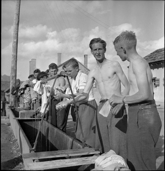 Young men washing themselves.
