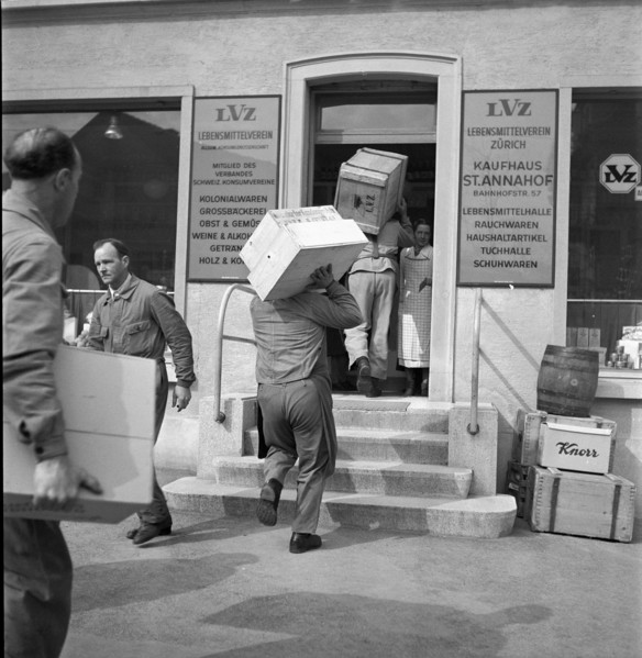 Storekeepers carry goods into the department store St. Annahof in Zurich, 1941.