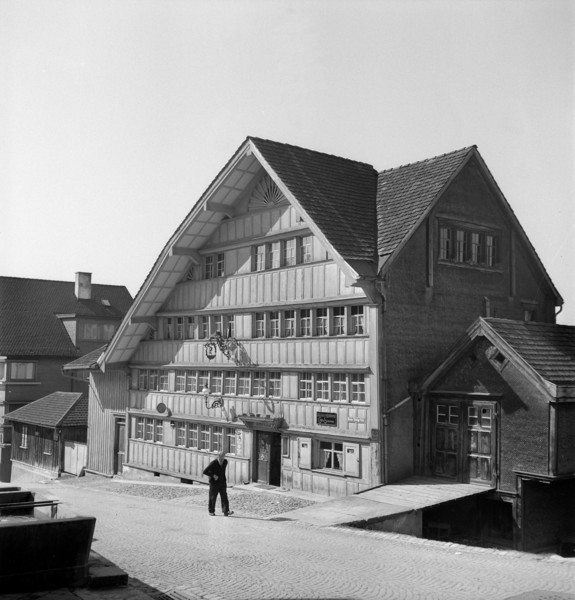 Herisau; Old man walking in a street; 1945.