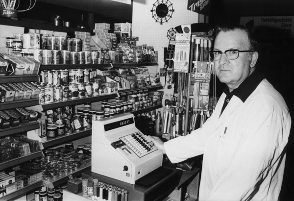 Sales person in food shop, around 1970