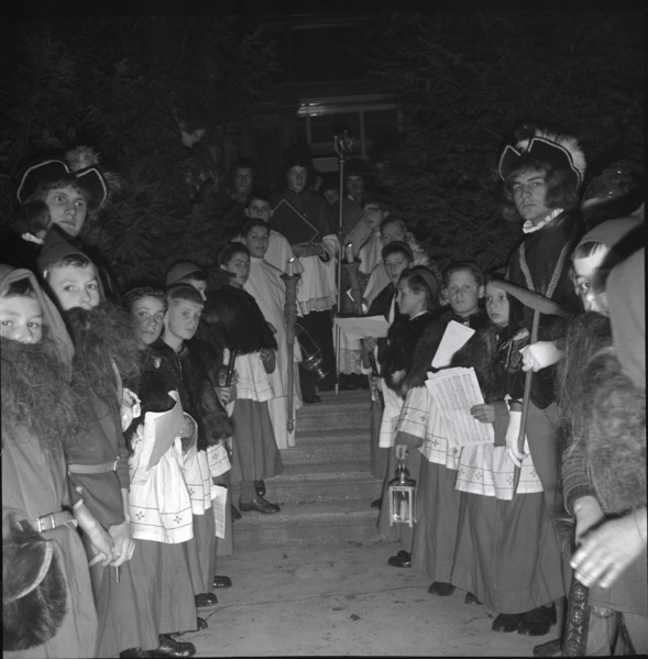 Children in historical costumes wait for Santa Claus in 1941