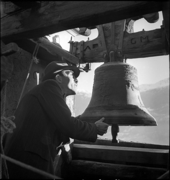 Man controlling church bells in village in Valais