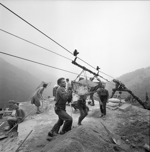Indemini, building material is unloaded from ropeway; 1960