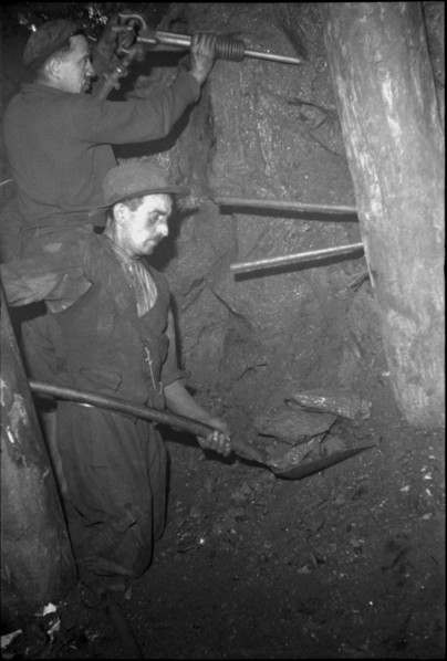 Miners in the tunnel; preparing the blast hole; 1942