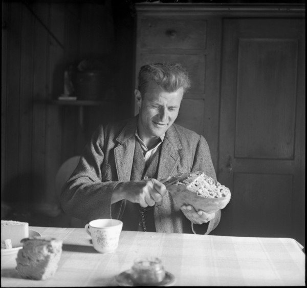 Farmer cutting bread, 1941