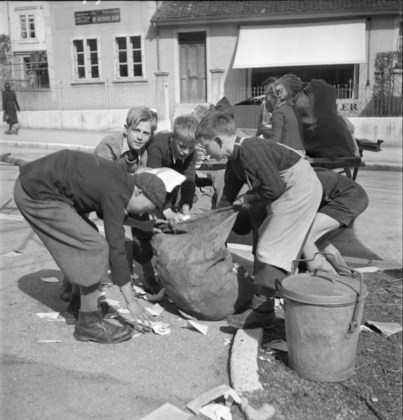 W K 2: war economics; young people collecting material to be recycled.