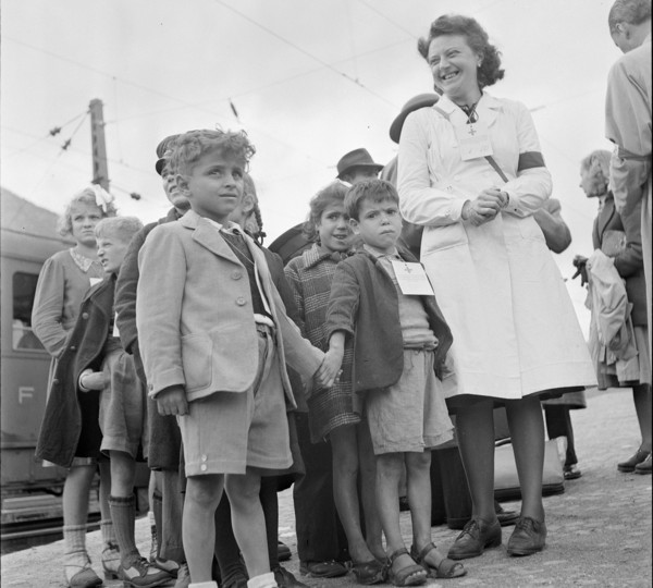 Red cross nurse with children from Domodossola; identification badge; 1944.