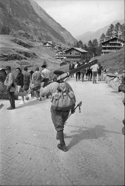 Skier carrying his skis, 1967.