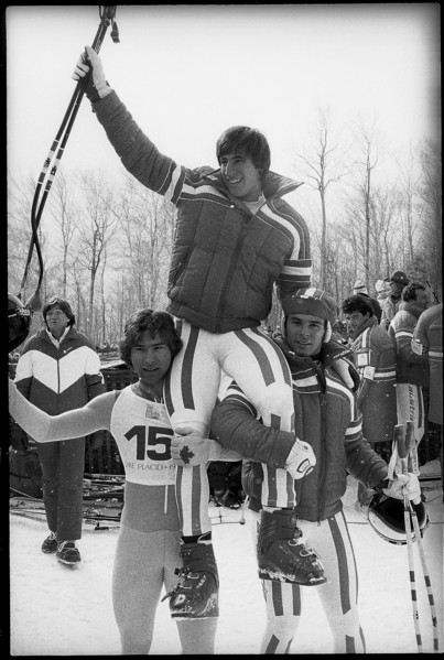 Olympic games Lake Placid 1980, downhill: Podborski and Wirnsberger carrying winner Stock on their
