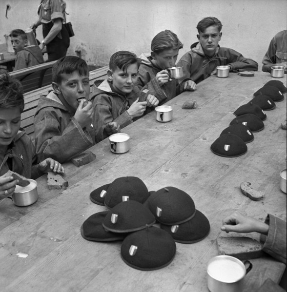 Together at the table with bread and drink.
