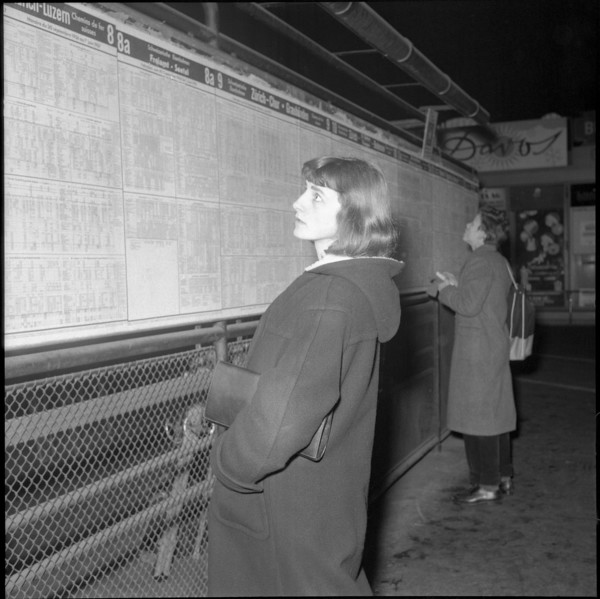Woman studies the Timetable, 1956.