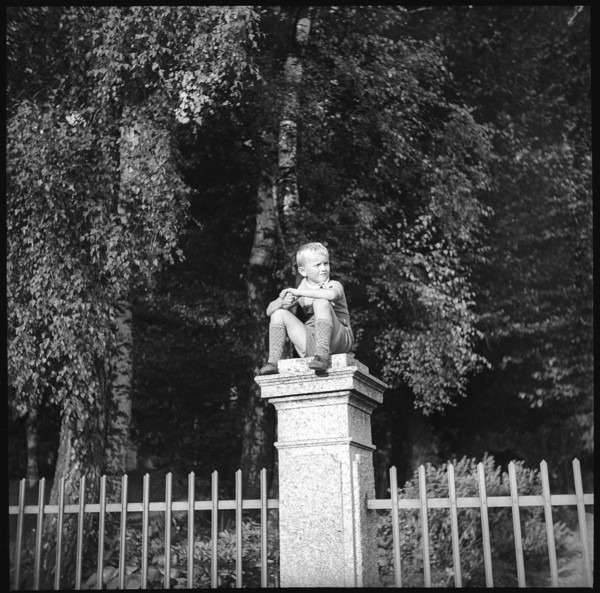 Boy sitting on a pillar, 1939.