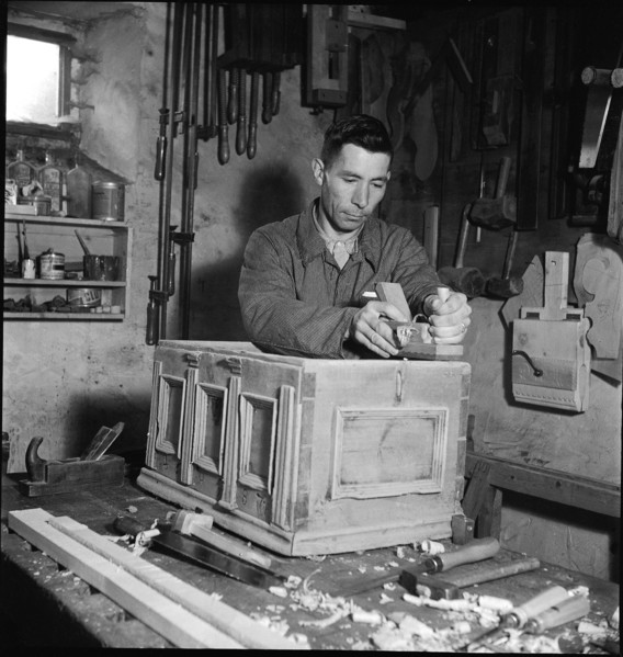 Man planing part of a cupboard, 1946.