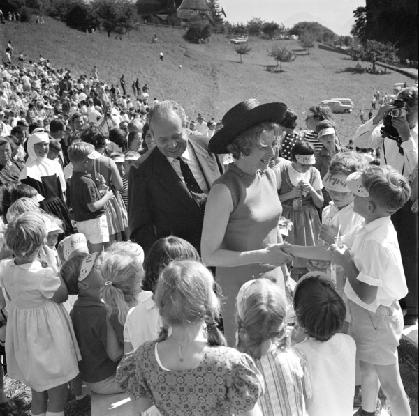 The Prince and his wife surrounded by children.