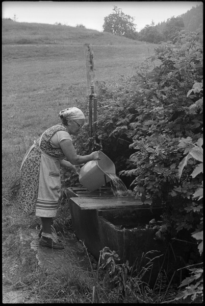 Old farmer at a fountain, Switzerland 1971.