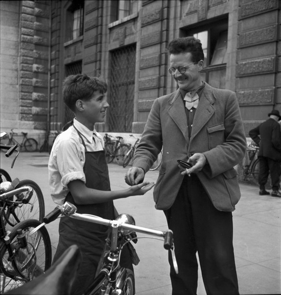 Basle, client paying for the cleaning of his bicycle; 1941.