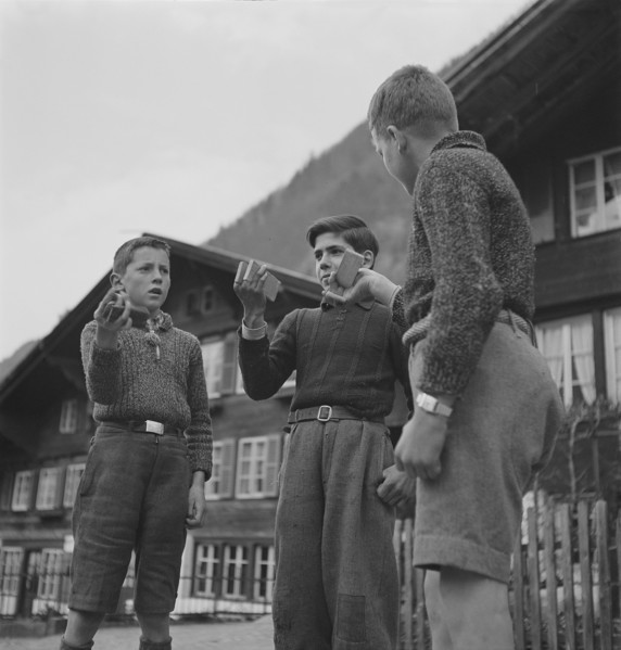 Boys making music with wood pieces, 1943.