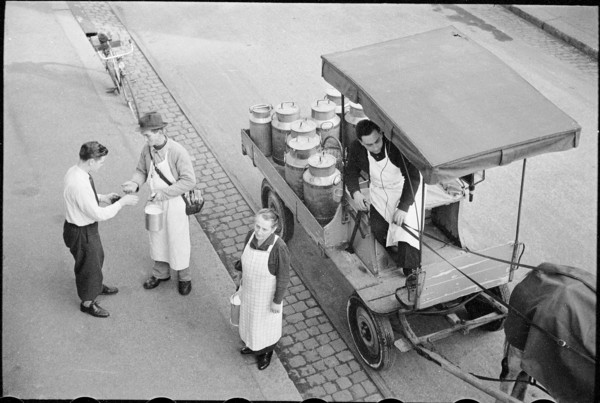 Milkman serving customers; 1941.