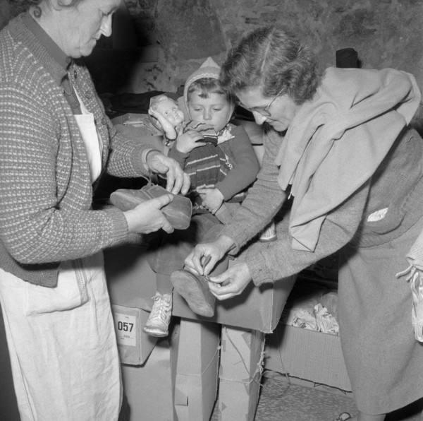 Hungarian women clothing a child, Uerikon 1956.