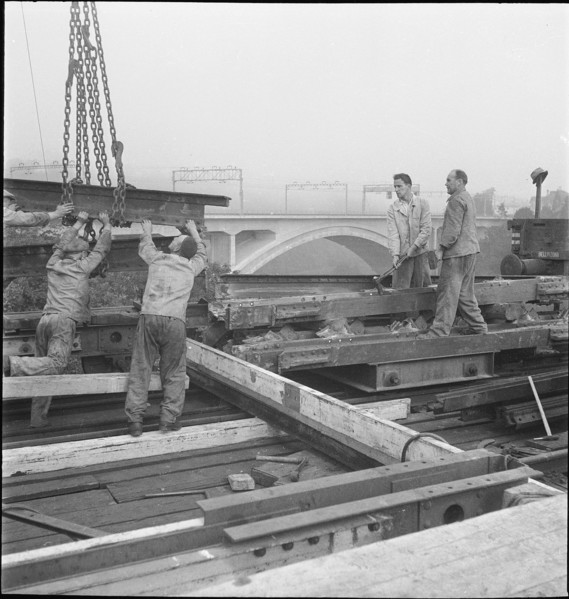 Construction worker demolishing a railway bridge 1941.