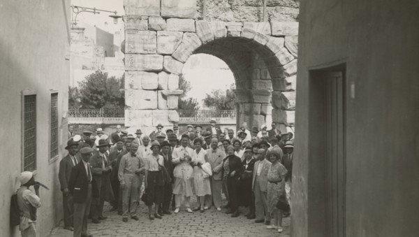 Excursionists in front of the Arch of Marcus Aurelius in Tripoli. 
	
		1931
