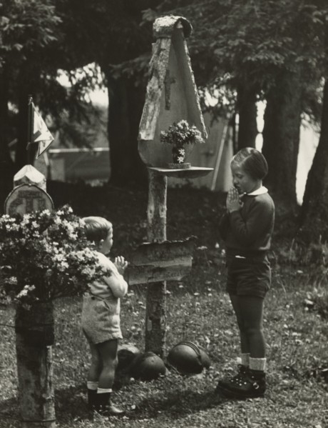 Touring Club campsite at the Pale di San Martino: two children at the camp altar. 1951