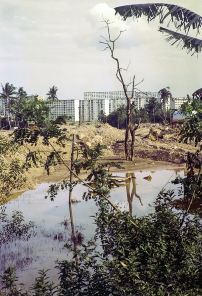 Destruction of farmland for construction site with modern blocks of flats residential housing,