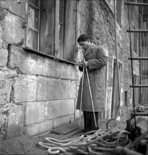Man checking structural fabric of a building in Geneva 1943