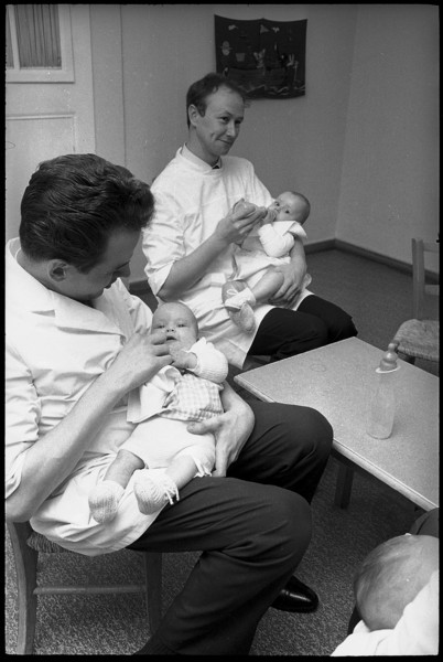 Men feeding babies, 1969