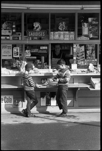 Boys buying sweets at a kiosk, Zurich 1966