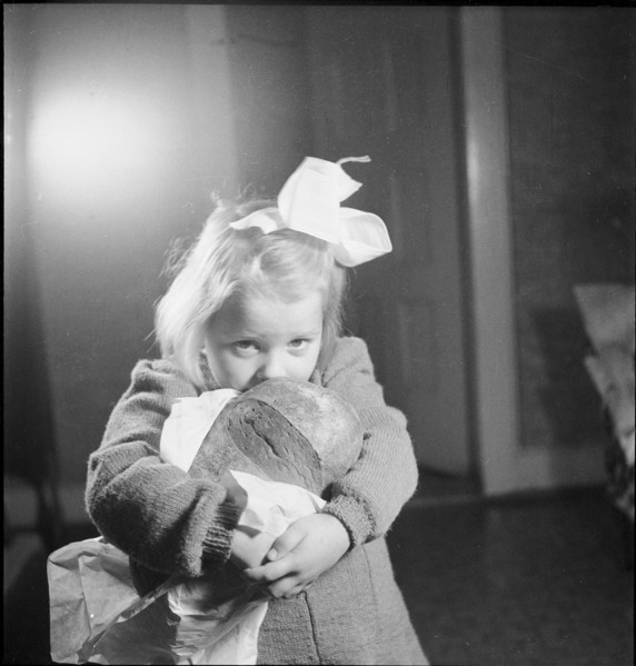 Girl with loaf of bread, approx. 1950