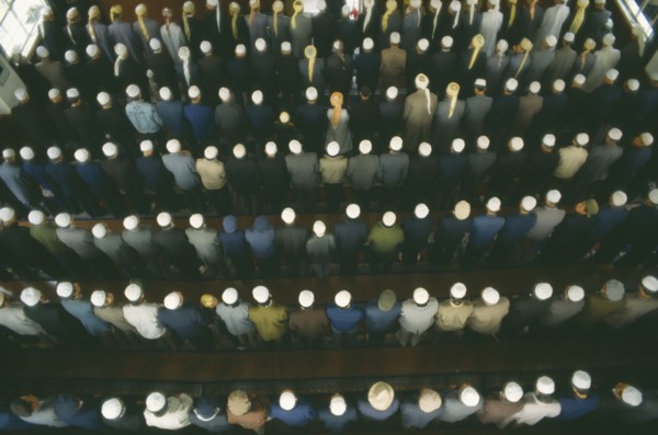 CHINA, Gansu Province, Lanzhou, View looking down on rows of praying Muslims in a Mosque on
