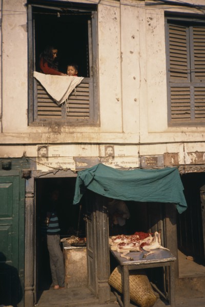 NEPAL, Kathmandu, Durbar Square butchers with display of goods and people at a window above