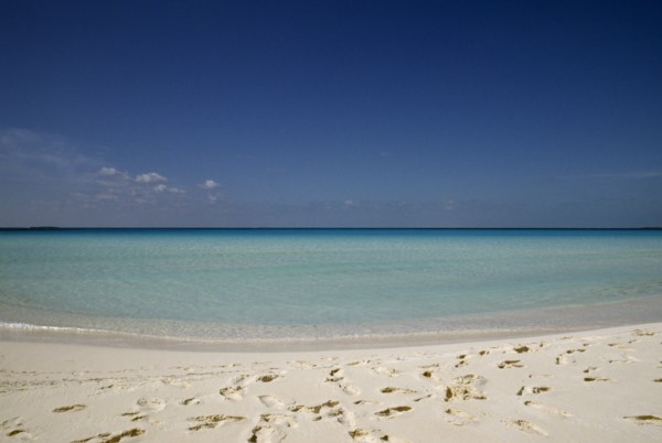 Cuba, Isla de Juventude, Caya Largo, Playa Serena, looking out to sea with footprints in white sand
